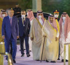In this photo provided by the Saudi Media Ministry, Turkish President Recep Tayyip Erdogan, left, walks with Saudi Arabia's King Salman, right, in Jiddah, Saudi Arabia, Thursday, April 28, 2022. Erdogan is visiting Saudia in a major reset of relations between two regional heavyweights following the slaying of a Saudi columnist in Istanbul. The Turkish presidency said talks in Saudi Arabia will focus on ways of increasing cooperation and the sides will exchange views on regional and international issues. (Saudi Media Ministry via AP)