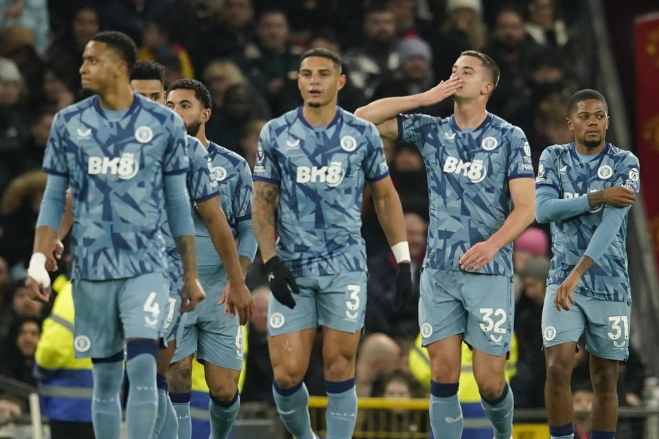 Aston Villa's Leander Dendoncker, centre right, celebrates after scoring his side's second goal during the English Premier League soccer match between Manchester United and Aston Villa at the Old Trafford stadium in Manchester, England, Tuesday, Dec. 26, 2023. (AP Photo/Dave Thompson)