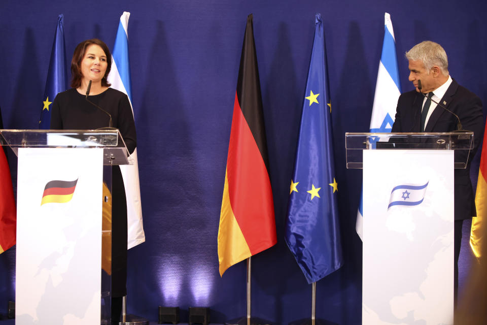 German Foreign Minister Annalena Baerbock and Israeli Foreign Minister Yair Lapid talk during a joint press conference in Tel Aviv, Israel, Thursday, Feb. 10, 2022. (AP Photo/Oren Ziv)