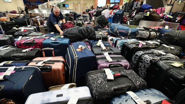 PHOTO: A Southwest Airlines employee sorts through unclaimed luggage at Hollywood Burbank Airport in Burbank, California, Dec. 27, 2022. (Robyn Beck/AFP via Getty Images)