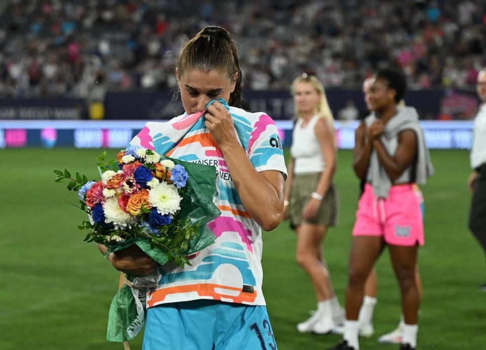 PHOTO: San Diego Wave FC forward Alex Morgan wipes her eyes after being sprayed with champagne following her final game of her career on Sept. 8, 2024, in San Diego. (Jonathan Hui/USA TODAY Sports via Reuters)