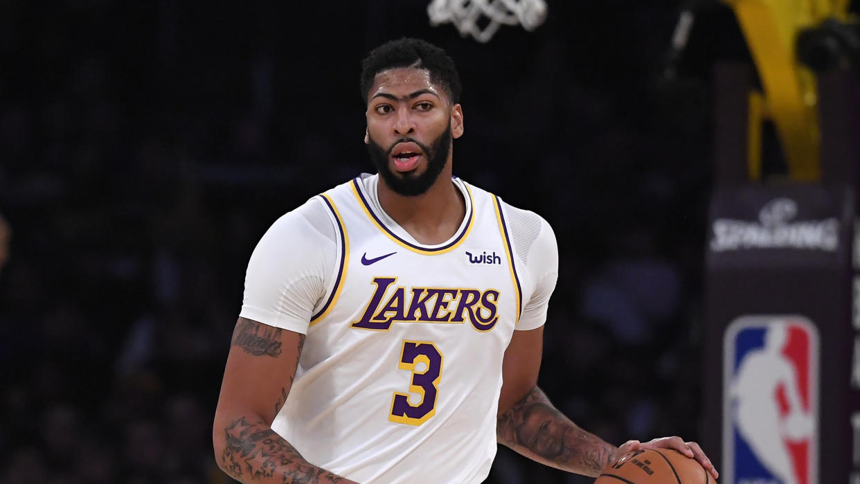 Los Angeles Lakers forward Anthony Davis dribbles during the first half of a preseason NBA basketball game against the Golden State Warriors Wednesday, Oct. 16, 2019, in Los Angeles. (AP Photo/Mark J. Terrill)