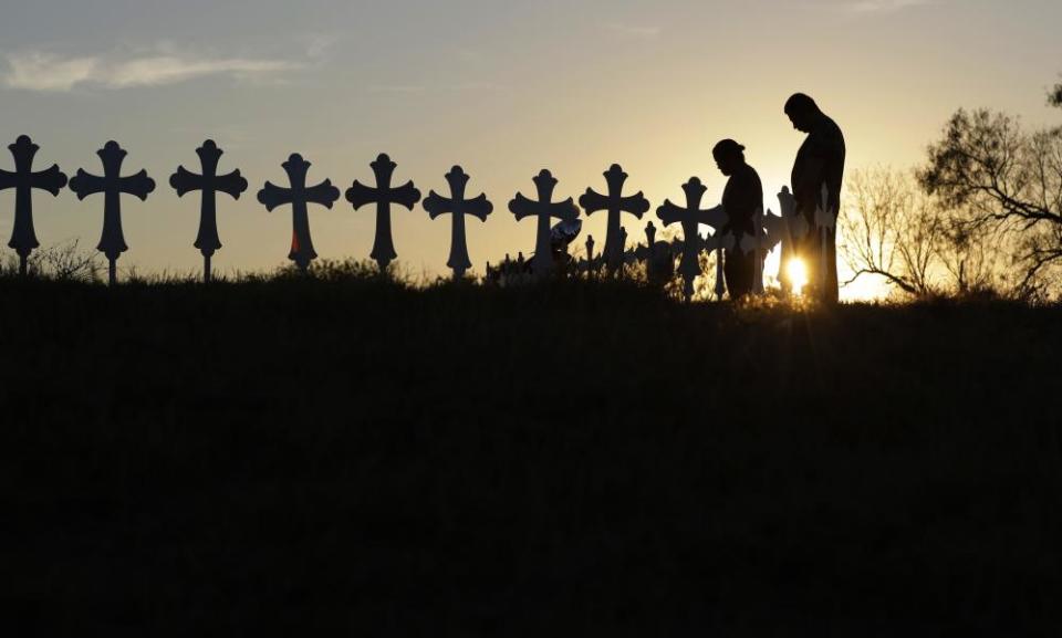 Kenneth and Irene Hernandez pay their respects as they visit a makeshift memorial with crosses placed near the scene of a shooting at the First Baptist Church of Sutherland Springs.