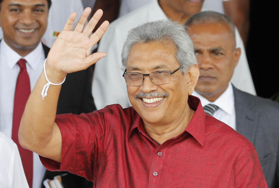 Sri Lankan presidential candidate and former defense chief Gotabaya Rajapaksa waves to media as he leaves the election commission after filing his nomination in Colombo, Sri Lanka, Monday, Oct. 7, 2019. A record 35 candidates filed nominations Monday for next month’s Sri Lankan presidential election, but the incumbent has opted not to seek a second term with the entry of Rajapaksa, who is considered the favorite. (AP Photo/Eranga Jayawardena)