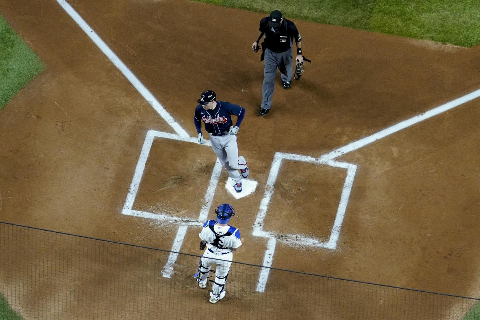 Atlanta Braves' Freddie Freeman scores after a home run during the first inning in Game 1 of a baseball National League Championship Series against the Los Angeles Dodgers Monday, Oct. 12, 2020, in Arlington, Texas.(AP Photo/David J. Phillip)