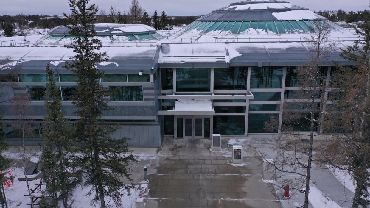 The entrance to the N.W.T. Legislative Assembly in Yellowknife.  N.W.T. resident Ashley Geraghty says he has tried every option to get his access to information request. But after the office that handles the request missed deadlines and ignored orders to provide documents, he says he is trying to enforce his right to access of information in court. (Travis Burke/CBC - image credit)