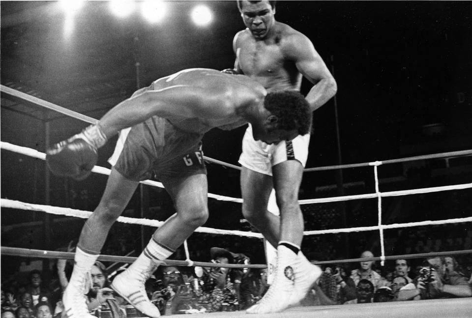 FILE - In this Oct. 30, 1974, file photo, challenger Muhammad Ali, top, watches as defending world champion George Foreman goes down to the canvas in the eighth round of their WBA/WBC championship match in Kinshasa, Zaire. The 1996 film "When We Were Kings" is a documentary of the bout known as the "Rumble In The Jungle" between Ali and Foreman. The fight was a cultural milestone that ran far deeper than boxing. (AP Photo/File)