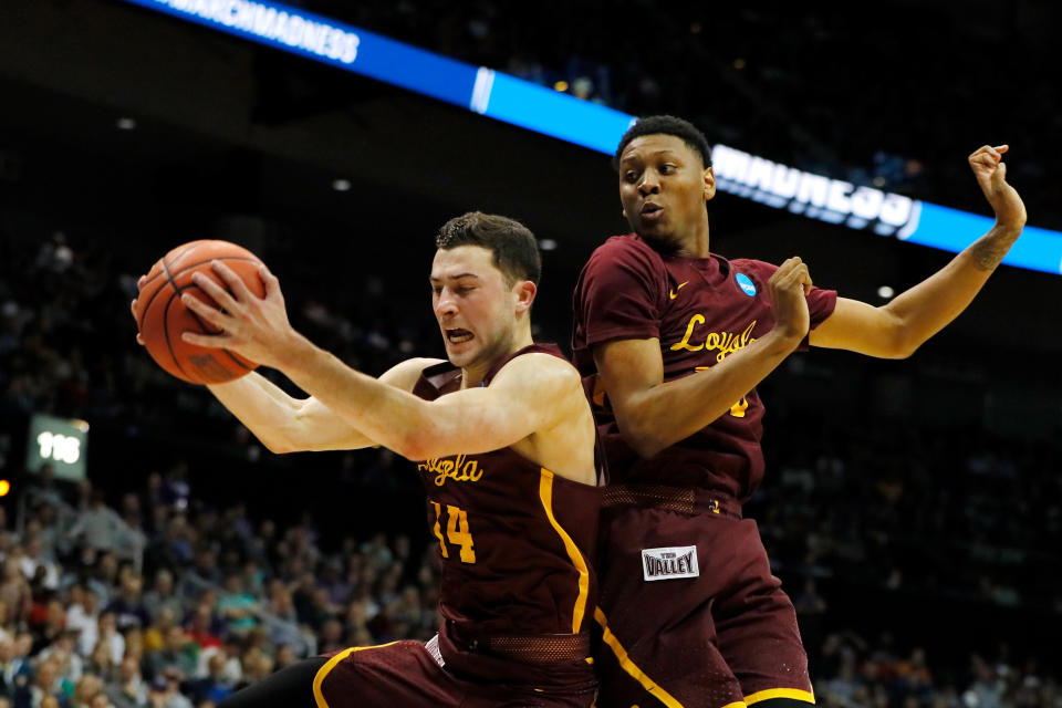 <p>Ben Richardson #14 of the Loyola Ramblers grabs the rebound as teammate Cameron Satterwhite #23 looks on against the Kansas State Wildcats in the first half during the 2018 NCAA Men’s Basketball Tournament South Regional at Philips Arena on March 24, 2018 in Atlanta, Georgia. (Photo by Kevin C. Cox/Getty Images) </p>