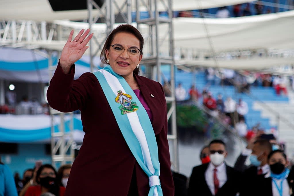 New Honduran President Xiomara Castro waves to invitees after being sworn-in, during a ceremony in Tegucigalpa (REUTERS)