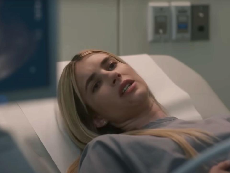 Emma Roberts as Anna, lying on a bed with a baby scan in shot