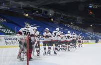 Ottawa Senators goalie Matt Murray (30) and teammates celebrate the team's 3-0 win over the Vancouver Canucks in an NHL hockey game Thursday, April 22, 2021, in Vancouver, British Columbia. (Darryl Dyck/The Canadian Press via AP)