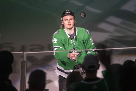 Apr 17, 2019; Dallas, TX, USA; Dallas Stars left wing Roope Hintz (24) throws a puck to the fans after being named the number one star after defeating the Nashville Predators in game four of the first round of the 2019 Stanley Cup Playoffs at American Airlines Center. Mandatory Credit: Jerome Miron-USA TODAY Sports