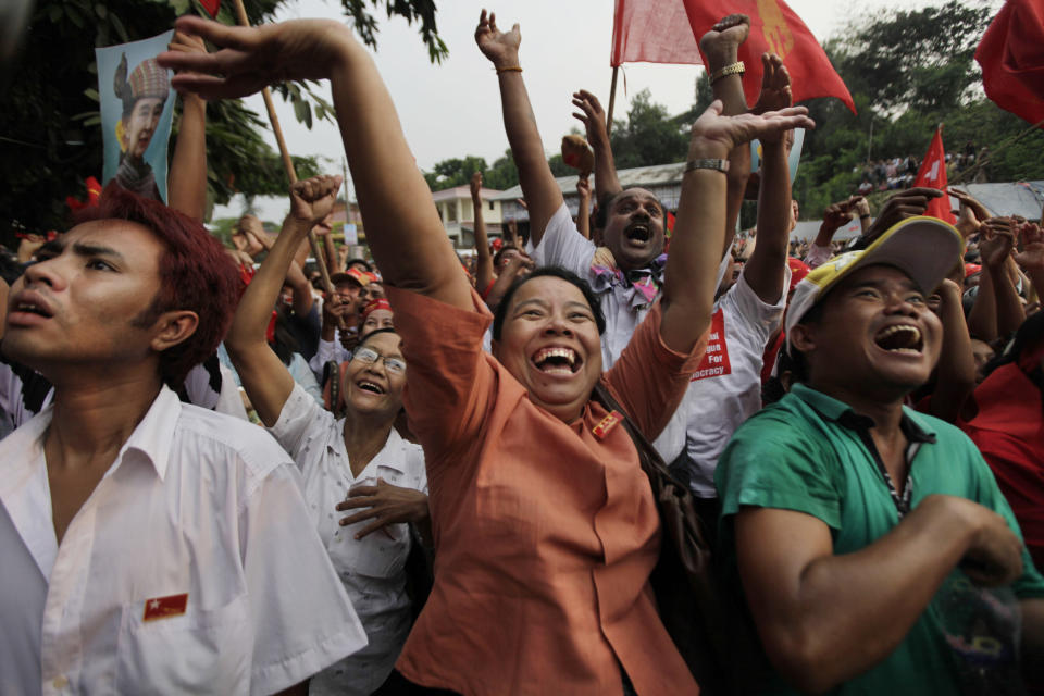 FILE - Supporters of Aung San Suu Kyi's National League for Democracy party cheer upon the party's announcement in Yangon, Myanmar on April 1, 2012. Myanmar court on Monday, Dec. 6, 2021, sentenced ousted leader Suu Kyi to 4 years for incitement and breaking virus restrictions, then later in the day state TV announced that the country's military leader reduced the sentence by two years. (AP Photo/Altaf Qadri, File)