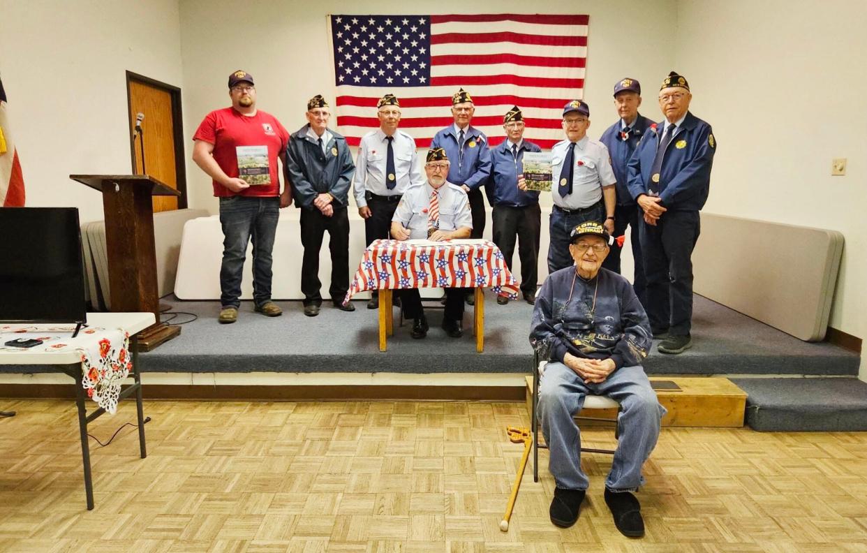 The Read-Veflin American Legion Post 180 in New Effington recently established the Read-Veflin American Legion Post 180 Scholarship Fund with the South Dakota Community Foundation. The scholarship will assist high school graduates from the New Effington and Roberts County area to pursue higher education in colleges and technical colleges. Picture are Morris Shelstad (Korean War), seated in front; Commander Russell McKee (seated) signing the scholarship agreement and back, left to right, Danny Curran, Butch Leen, Jerold Krueger, Art Brandenburger, Neil Fritz, Cecil Strangeland, Curtis Stowe and Keith Bostrom.