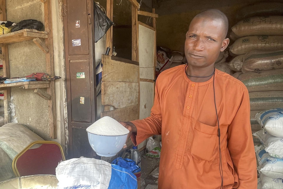 Isa Ahmed shows the granulated sugar he sells at his shop at a market in Abuja, Nigeria, Friday, Oct. 27, 2023. Sugar worldwide is trading at the highest prices since 2011, mainly due to lower global supplies after unusually dry weather damaged harvests in India and Thailand, the world's second and third-largest exporters. (AP Photo/Chinedu Asadu)