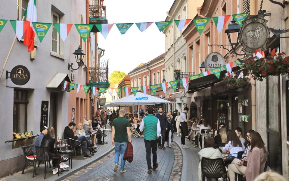 People sit in cafes during a tourism event to mimicking the Italian holiday experience in Vilnius, Lithuania  - AFP