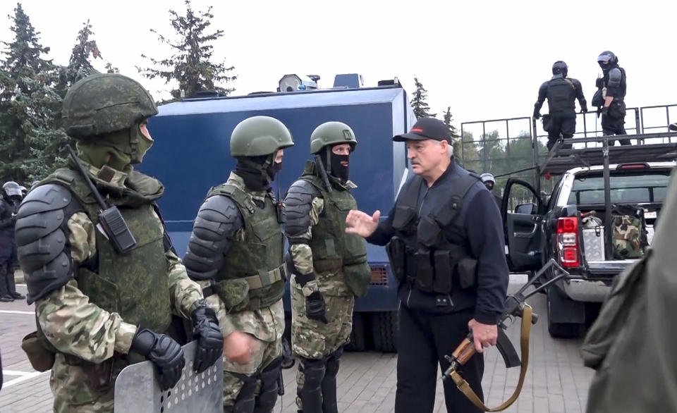 FILE - In this Aug. 23, 2020, file image made from video provided by the State TV and Radio Company of Belarus, Belarus President Alexander Lukashenko greets riot police officers near the Palace of Independence in Minsk, Belarus. With protests in Belarus now in their third week — including rallies that brought out an estimated 200,000 people in Minsk for the last two Sundays — the authoritarian leader is moving to squelch the demonstrations gradually with vague promises of reforms mixed with threats, court summonses and the selective jailing of leading activists. (State TV and Radio Company of Belarus via AP, File)