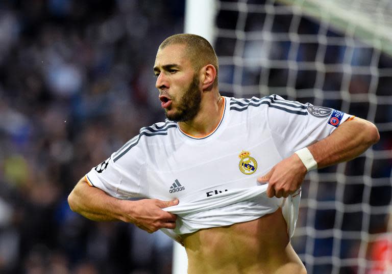 Real Madrid's French forward Karim Benzema celebrates after scoring during the UEFA Champions League semifinal first leg football match Real Madrid CF vs FC Bayern Munchen at the Santiago Bernabeu stadium in Madrid on April 23, 2014