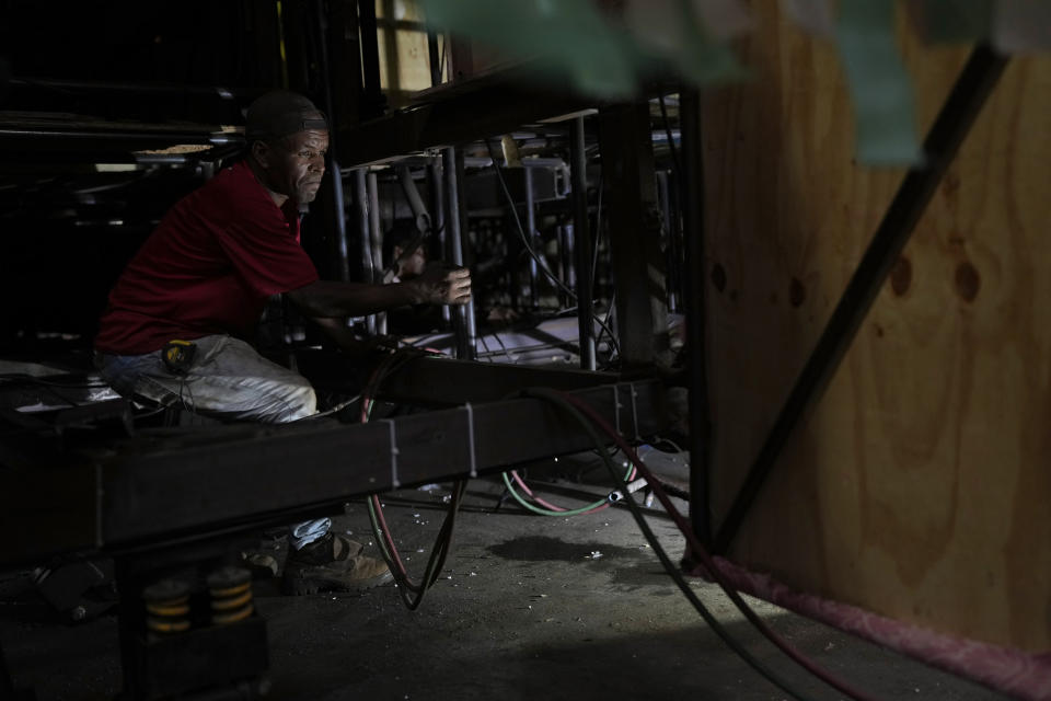 A worker from the Paraiso do Tuiuti samba school builds a float at the Samba City complex in Rio de Janeiro, Brazil, Thursday, Feb. 9, 2023. Samba schools are already gearing up for next Carnival, building the colorful floats and stitching together the costumes. (AP Photo/Silvia Izquierdo)