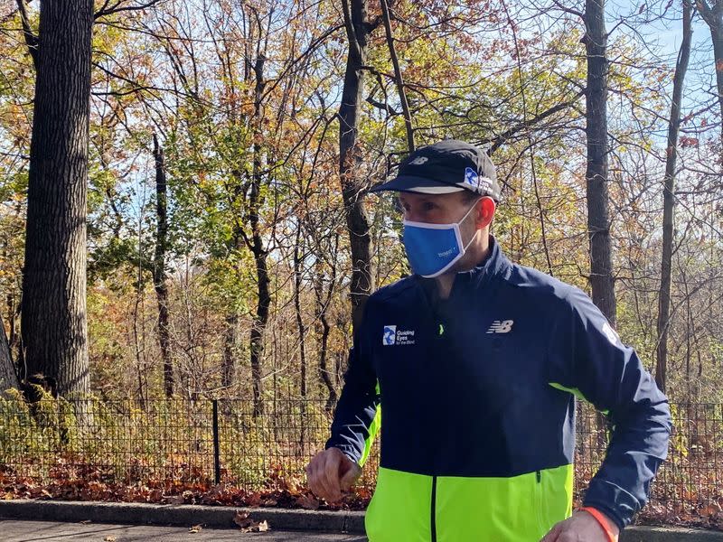 Thomas Panek, a blind runner and CEO of Guiding Eyes for the Blind, gets ready for a 5K run in Central Park where he will use Google's "Guideline" app instead of help from a human or guide dog, in New York