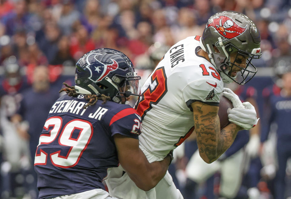 Nov 5, 2023; Houston, Texas, USA; Tampa Bay Buccaneers wide receiver Mike Evans (13) is tackled by Houston Texans safety M.J. Stewart (29) in the first quarter at NRG Stadium. Mandatory Credit: Thomas Shea-USA TODAY Sports