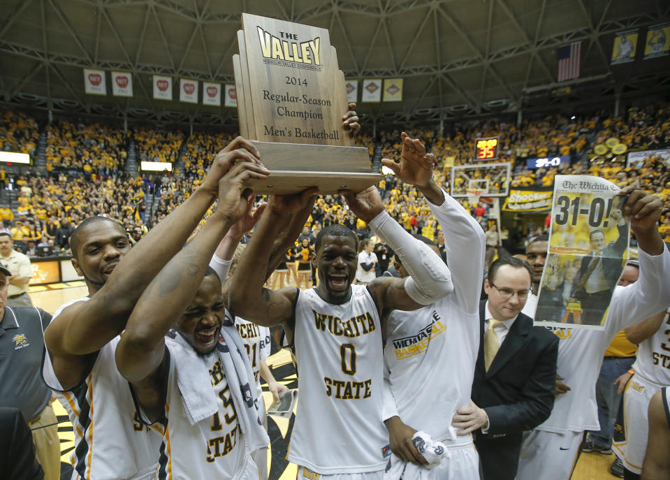 Wichita State players hold up the Missouri Valley Conference regular season trophy after beating Missouri State 68-45 in an NCAA college basketball game in Wichita, Kansas., Saturday, March 1, 2014. (AP Photo/The Wichita Eagle, Travis Heying) LCOAL TV OUT; MAGS OUT; LOCAL RADIO OUT; LOCAL INTERNET OUT