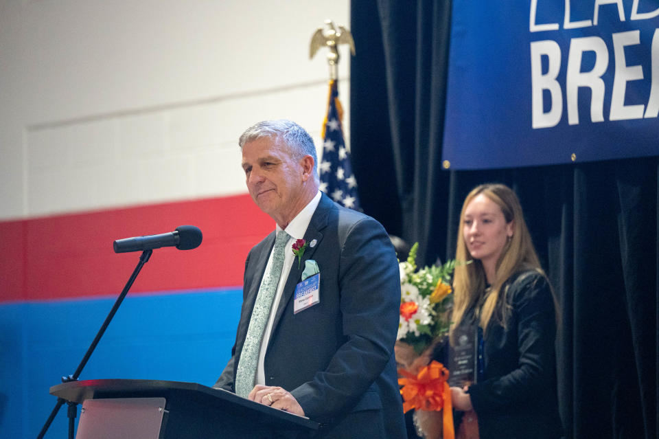 Steve Cantees receives his Leadership Award after a presentation by Venice High senior Mallory L. and Pine View senior Juna H.