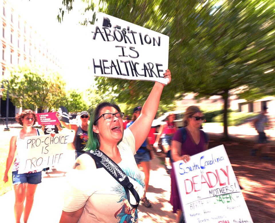 A group participates in a rally in front of the State House in Columbia, Tuesday morning, July 19, 2022. The rally was organized by the Women's Rights and Empowerment Network (WREN) in response to the House ad hoc committee's second hearing on abortion legislation.