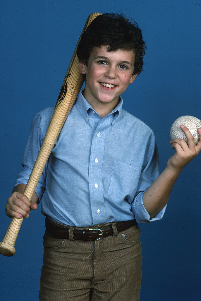 fred is about 12 he is holding a baseball bat