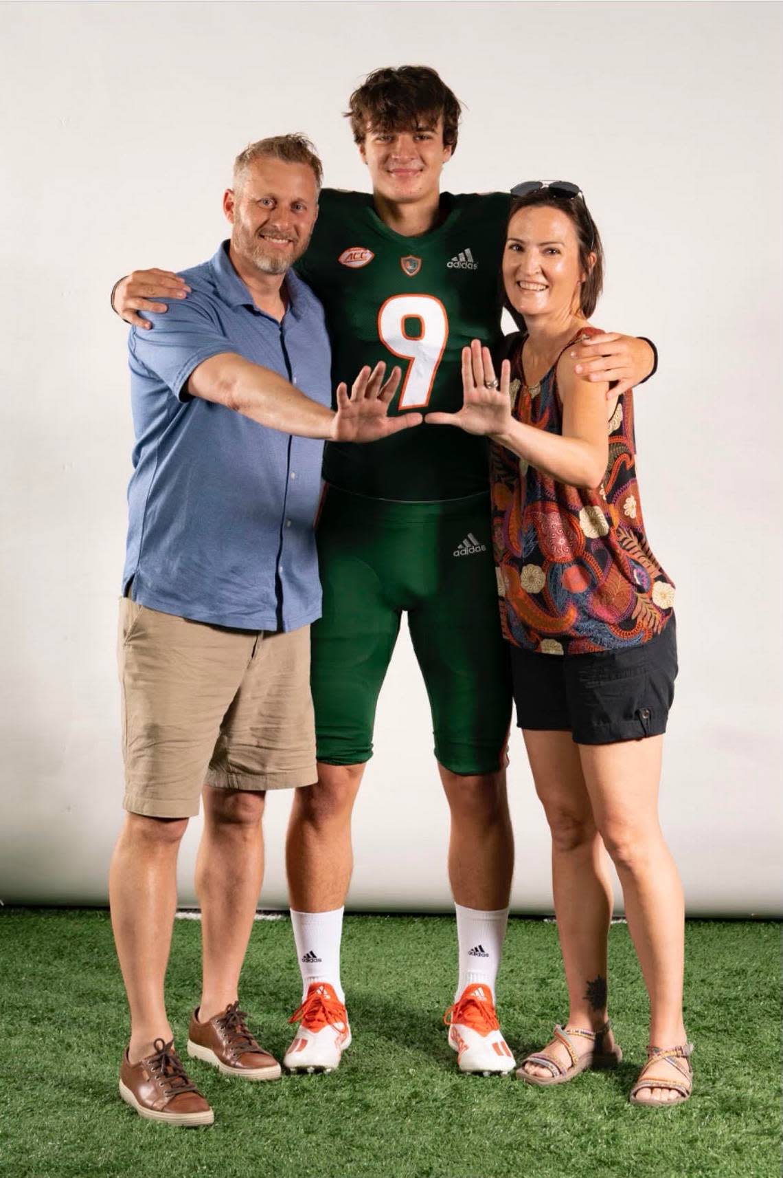 University of Miami quarterback commit Emory Williams poses with his father Steve and mother Melissa in June, 2022.