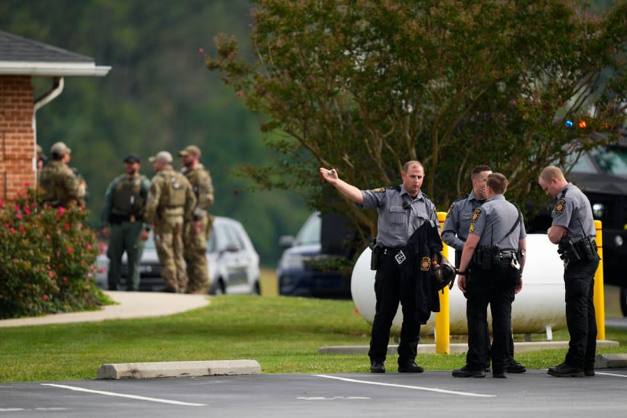 Law enforcement agents stand by as Danelo Souza Cavalcante sits inside an armored vehicle at the Pennsylvania State Police barracks at Avondale Pa., on Wednesday, Sept. 13, 2023. Cavalcante was captured Wednesday after eluding hundreds of searchers for two weeks. (AP Photo/Matt Rourke)