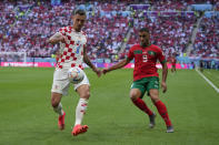 Croatia's Dejan Lovren, left, vies for the ball with Morocco's Abderrazak Hamdallah during the World Cup group F soccer match between Morocco and Croatia, at the Al Bayt Stadium in Al Khor , Qatar, Wednesday, Nov. 23, 2022. (AP Photo/Thanassis Stavrakis)