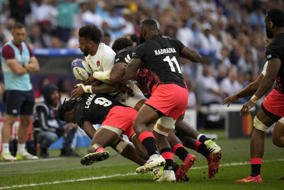 England's Courtney Lawes is driven into touch during the Rugby World Cup quarterfinal match between England and Fiji at the Stade de Marseille in Marseille, France, Sunday, Oct. 15, 2023. (AP Photo/Daniel Cole)