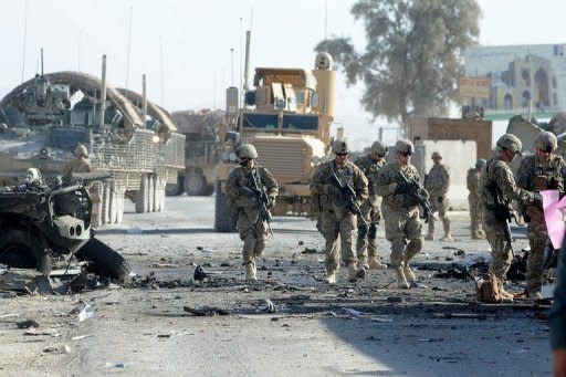 US soldiers arrive at the site of a suicide attack near the gate of Kandahar international airport on January 19. A suicide bomber attacked foreign military forces in northern Afghanistan on Wednesday, killing at least 12 people including three international troops, officials said