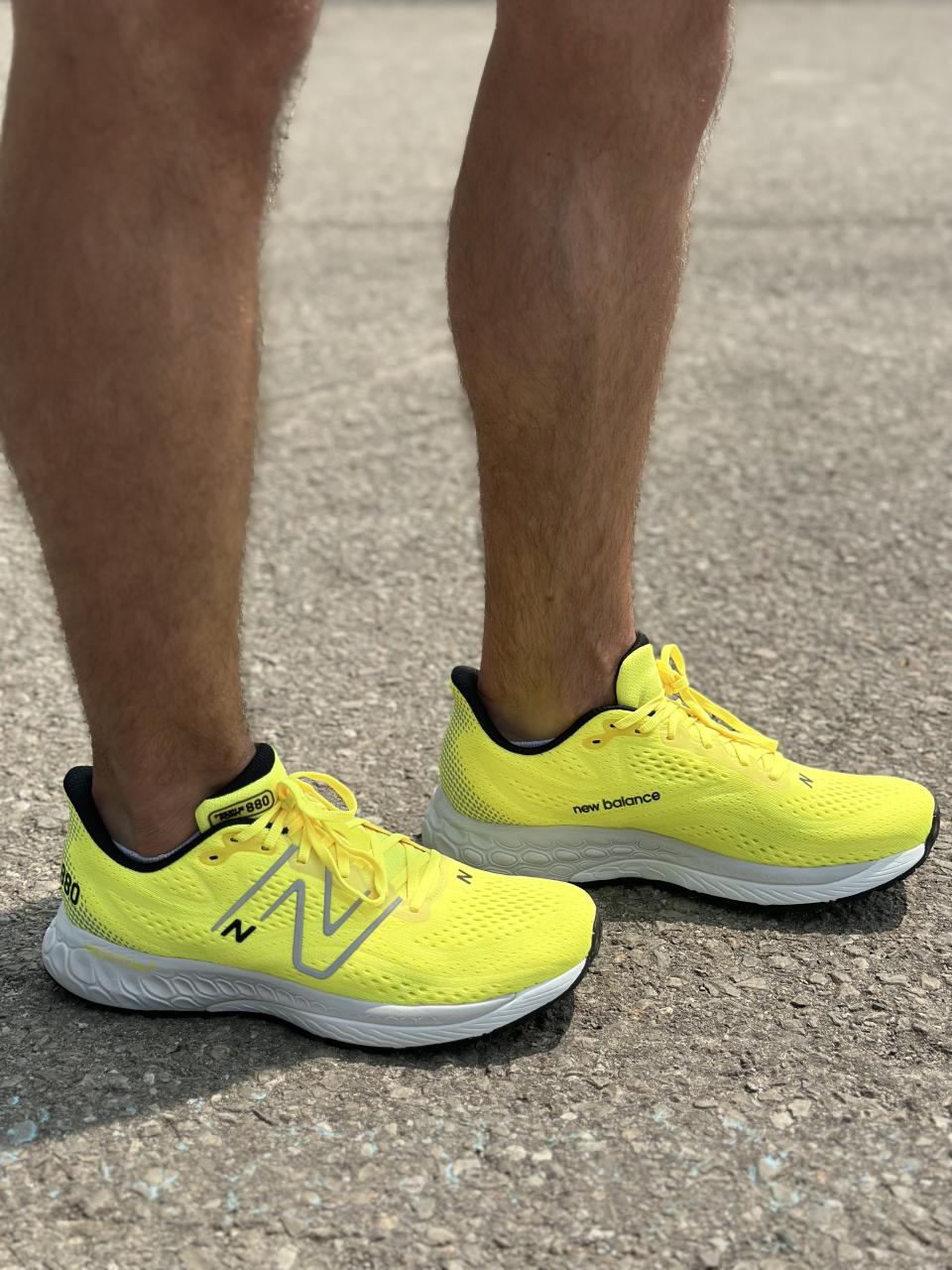 man wearing neon yellow running shoes on pavement, New Balance Fresh Foam X 880 V13 sneakers in yellow