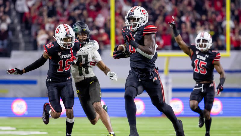Utah Utes linebacker Devin Lloyd (0) runs back an intercepted pass to score, putting the Utes up 14-0 over the Oregon Ducks in the Pac-12 championship game at Allegiant Stadium in Las Vegas on Friday, Dec. 3, 2021.