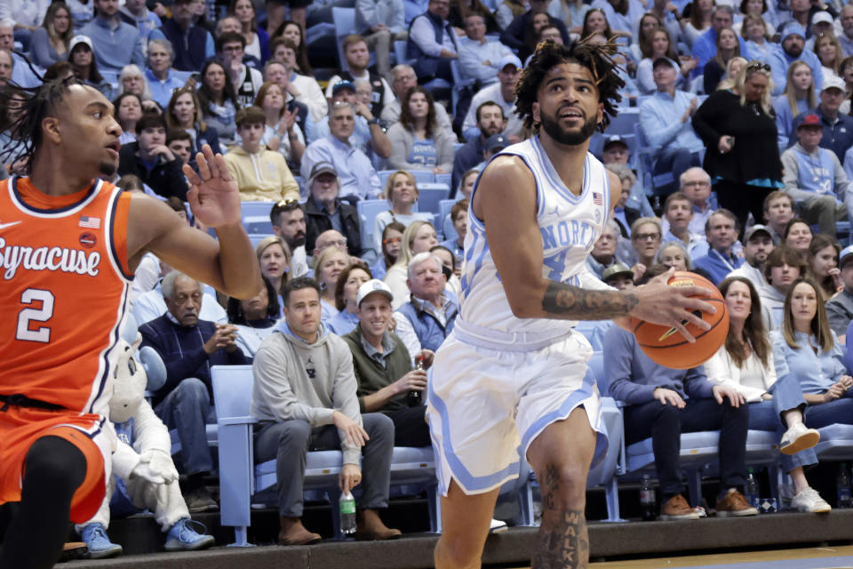 North Carolina guard RJ Davis (4) drives past Syracuse guard JJ Starling (2) during the first half of an NCAA college basketball game Saturday, Jan. 13, 2024, in Chapel Hill, N.C. (AP Photo/Chris Seward)