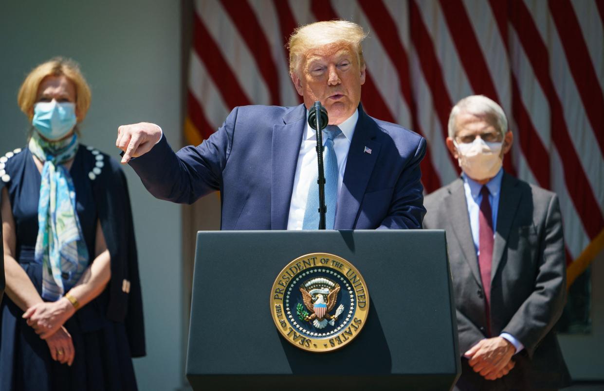 US President Donald Trump speaks on vaccine development in the Rose Garden of the White House in Washington, DC, flanked by White House Coronavirus Task Force Deborah Birx and Director of the National Institute of Allergy and Infectious Diseases Anthony Fauci (AFP via Getty Images)