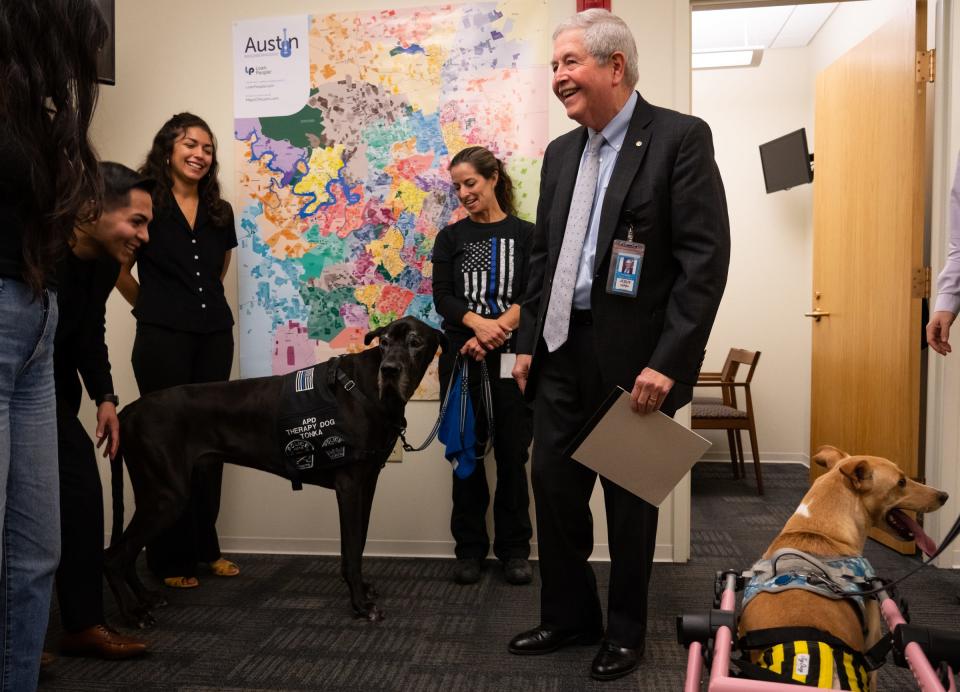 Jesús Garza stops to greet therapy dogs on his way to a meeting with City Council Member Ryan Alter at City Hall last month.