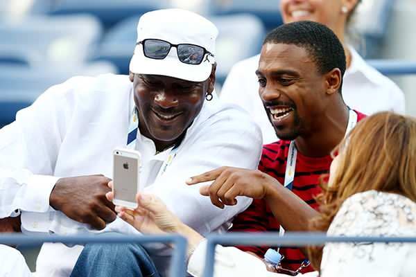 Michael Jordan sharing a joke with Federer's wife, Mirka. Pic: Getty