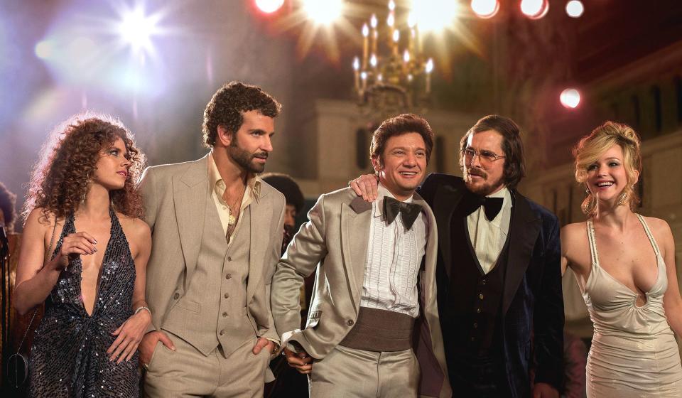 Here's the A-list cast of 2013's <em>American Hustle</em>, in which Cooper played the curly-haired, ambitious Richie DiMaso alongside Amy Adams, Jeremy Renner, Christian Bale and Jennifer Lawrence.