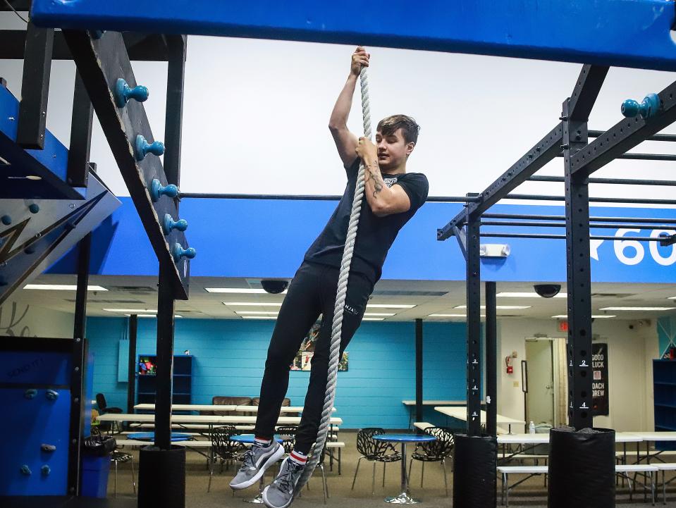 Twenty-one-year-old Drew Nester climbs a rope up to the ceiling at 605 Ninja on Tuesday, June 7. He has been doing ninja training since he was 14 and is now a trainer at 605 Ninja.