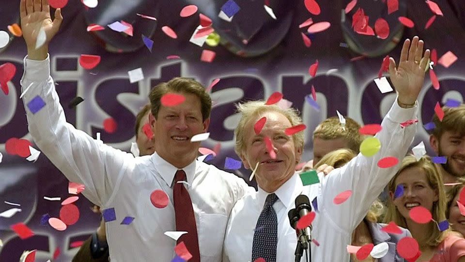 US Vice President and Democratic Presidential Candidate Al Gore (L) and US Senator Joseph Lieberman (R) salute the crowd at a rally where Gore formally announced Lieberman as his vice presidential running mate in Nashville, Tennessee, 08 August 2000. - Tannen Maury/AFP/Getty Images