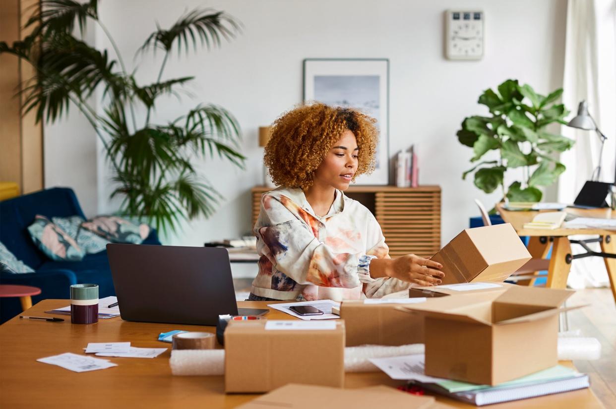 Woman packing sold items at home