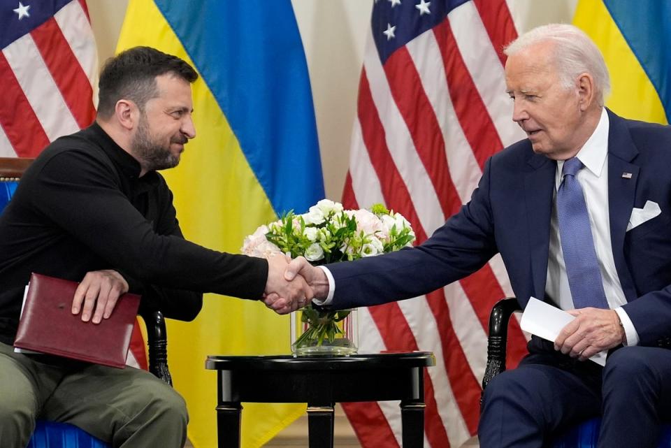 U.S. President Joe Biden shakes hands with Ukrainian President Volodymyr Zelenskyy in Paris, Friday, June 7, 2024. (AP Photo/Evan Vucci) (AP)