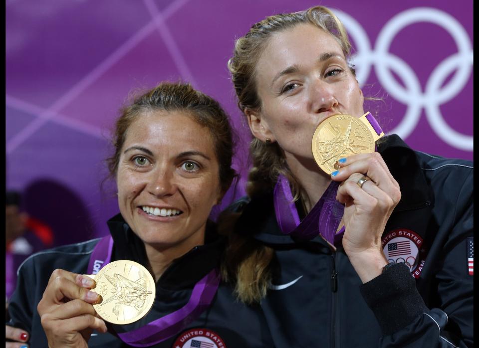 The United State's Misty May-Treanor, left, and Kerri Walsh Jennings celebrate with their Gold Medals following a win over April Ross and Jennifer Kessy, also of the United States, in the women's Gold Medal beach volleyball match at the 2012 Summer Olympics, Wednesday, Aug. 8, 2012, in London. 