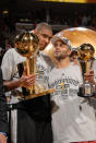 <p>2007: Tim Duncan #21 and Finals MVP Tony Parker #9 of the San Antonio Spurs celebrate with the Larry O'Brien Trophy and MVP Trophy after they won the NBA Championship with their 83-82 win against the Cleveland Cavaliers in Game Four of the NBA Finals at the Quicken Loans Arena on June 14, 2007 in Cleveland, Ohio.</p>