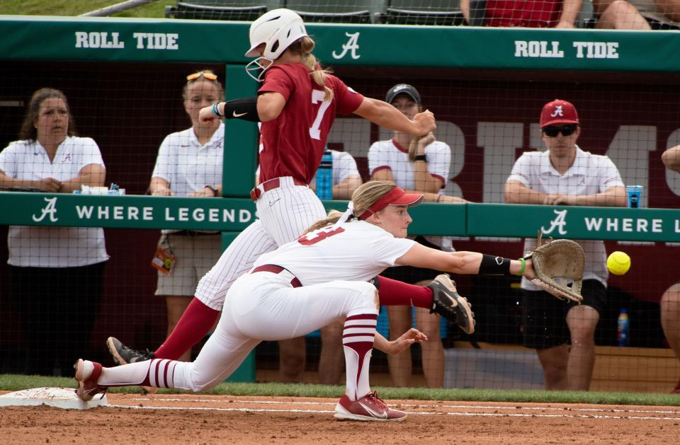 May 22, 2022; Tuscaloosa, AL, USA; Alabama shortstop Bailey Dowling (7) beats out a infield hit as Stanford utility player Emily Schultz (13) stretches out for the throw during the regional final Sunday at Rhoads Stadium. Alabama defeated Stanford 4-0 to force a deciding second game. Mandatory Credit: Gary Cosby Jr.-The Tuscaloosa News