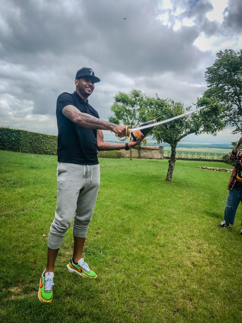 <h1 class="title">Sabrage! Enjoying lunch at the Veuve Clicquot vineyard.</h1><cite class="credit">Photo: Rae-Vaughn Lucas / Courtesy of Carmelo Anthony</cite>