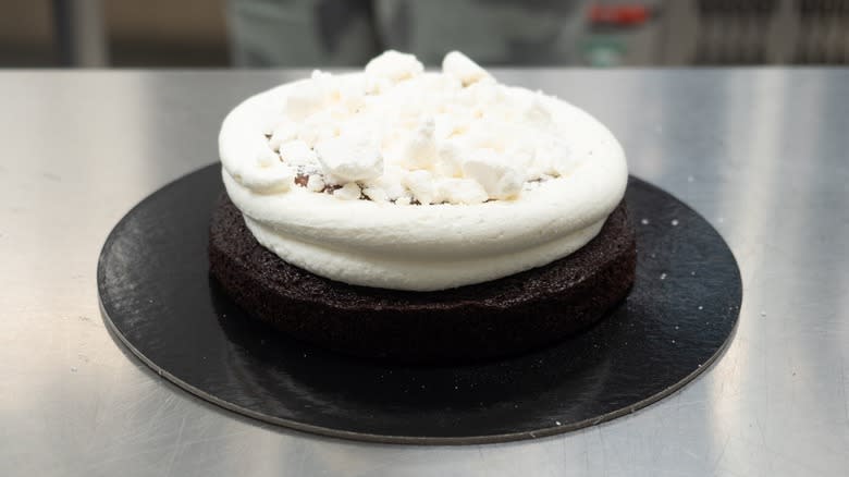 cake with caramel and meringue inside buttercream dam